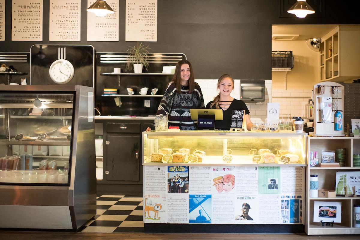 Two baristas at the coffee bar