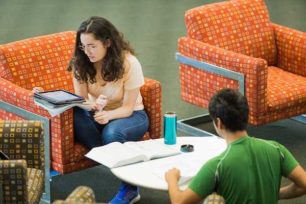 Students sitting in chairs, reading